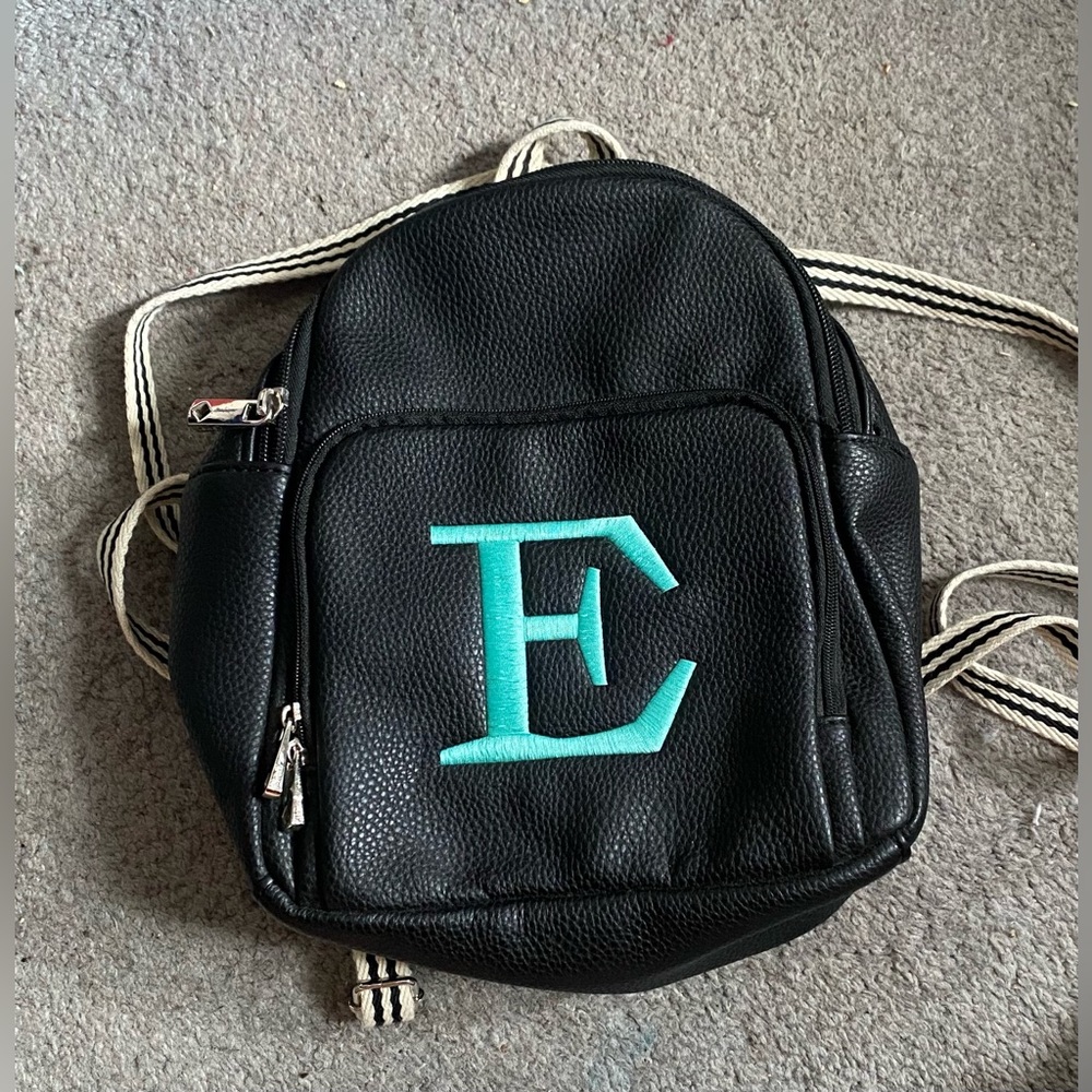 Thirty-one pleather mini backpack with turquoise “E”